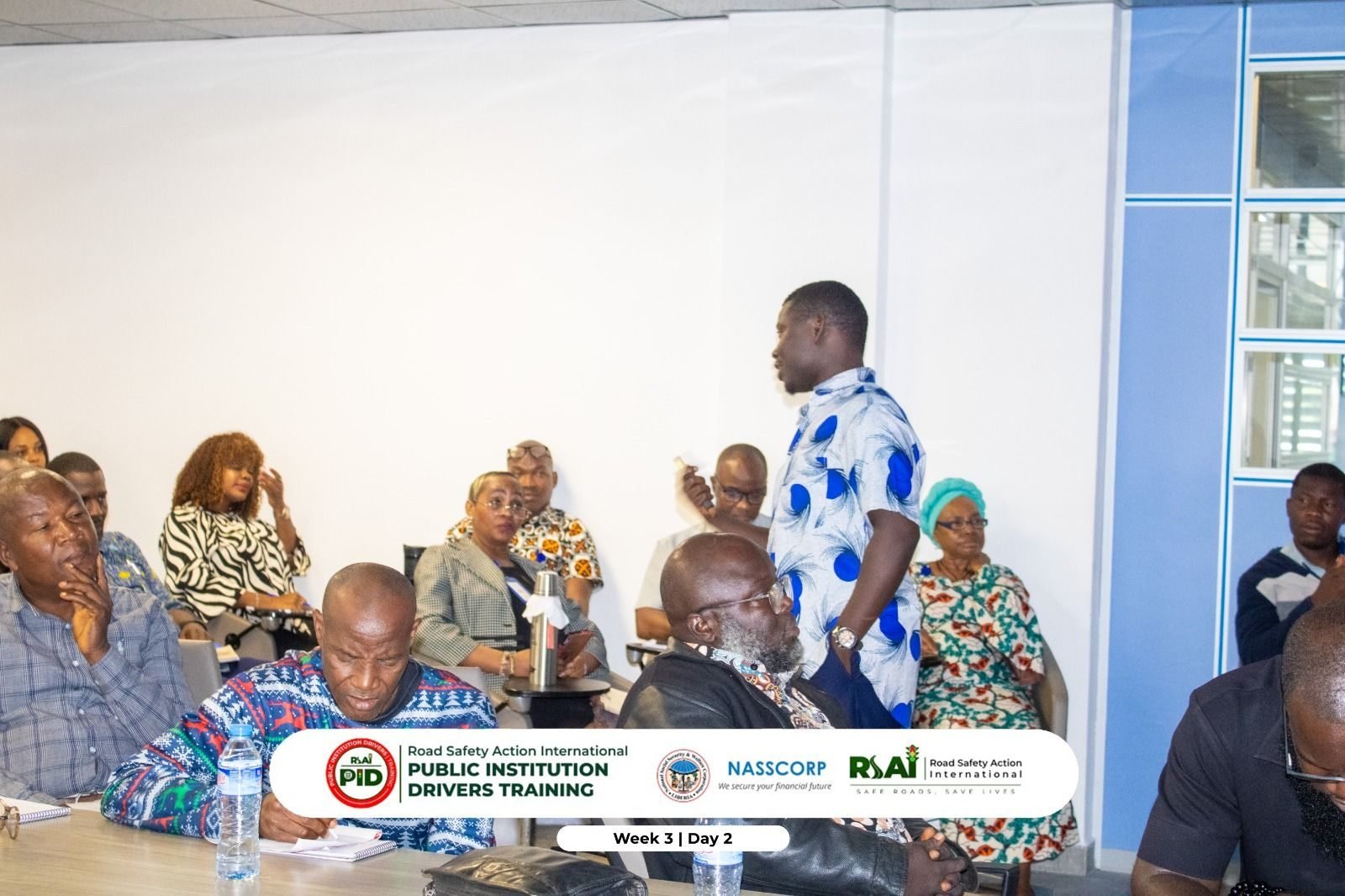 A participant stands to contribute during group discussion